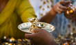 People shop for bronze and other metal items at a roadside stall on Dhanteras, in Guwahati...