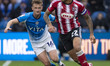 Josh Magennis #27 of Exeter City F.C. is challenged by Callum Connolly #16 of Stockport Co...
