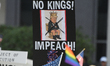 Protesters in Orlando, Florida, on Saturday morning, hold flags and chant the slogan ''No...
