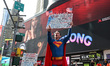 A man dressed as Superman holds up a placard during the ''No Kings Protests'' at Times Squ...