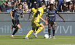 Ebenezer Akinsanmiro of Pisa SC competes for the ball with Roberto Gagliardini of Hellas V...