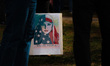 A sign depicting a woman in an American flag hijab with the words ''We the People Are Grea...