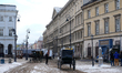 Extras and crew work amidst period-set facades on Krakowskie Przedmieście in Warsaw, Polan...
