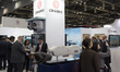 Military officials and visitors from various countries tour the L3Harris booth during the...