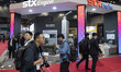 Military officials and visitors from various countries tour the STX Engine booth during th...
