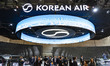 Military officials and visitors from various countries tour the Korean Air booth during th...