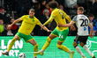 Jovon Makama of Norwich City holds off Callum Elder of Derby County as he passes the ball...
