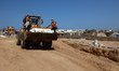 Bodies of unidentified Palestinians return from Israel as part of the ceasefire deal and a...