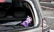A soft toy is in the back of a damaged car outside a private kindergarten in the Kholodnoh...
