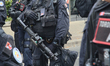 Police stand ready with tear gas launchers during an anti-immigration rally and pro-immigr...