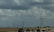 A view of transmission lines and cars on a road in Texas, United States on October 23, 202...