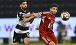 Hasan Khalid Alhaydos of Al Sadd SC and Abdulla Hassan Al-Marafi of Al Arabi SC are in act...