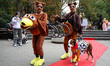Two women walk their dog down the red carpet and pose for a photo during the Washington Sq...