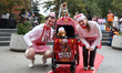 A couple and their dachshund dress as ''Willie Weiners'' and pose for a photo during the W...