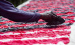 An Indonesian worker makes colored batik-patterned fabric on a riverbank in Sukoharjo, Cen...