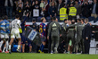 Vinicius Junior of Real Madrid is escorted off the pitch as he gestures towards Lamine Yam...