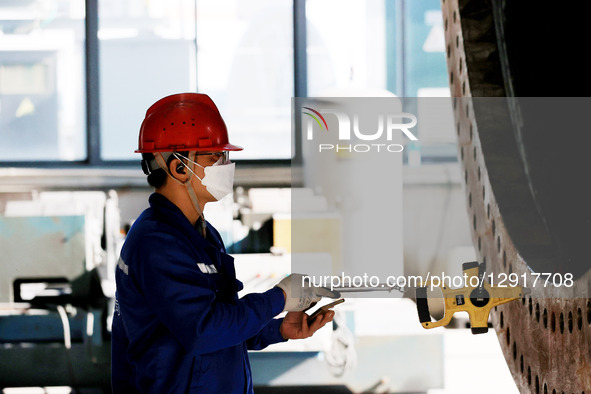 Workers work on the production line of a tower manufacturing company's workshop in Liuzhou, Guangxi, China, on October 27, 2025.  by Costfoto/NurPhoto