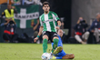 Marcos Llorente of Atletico de Madrid competes for the ball with Ez Abde of Real Betis dur...