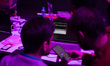 Two hackers compete in the cybersecurity section of Iran's 2025 Tech Olympics in Tehran, I...