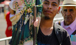 A devotee attends the Church of San Hipolito to bless the images of Saint Jude and give th...