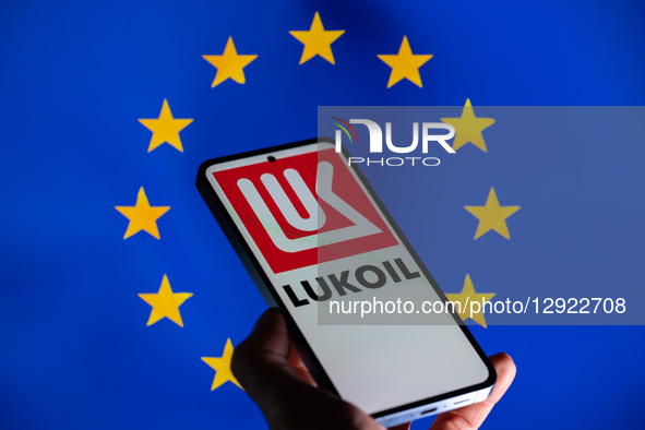 The Lukoil logo is displayed on a mobile phone with the European flag in the background, in this photo illustration in Brussels, Belgium, on... by Jonathan Raa/NurPhoto