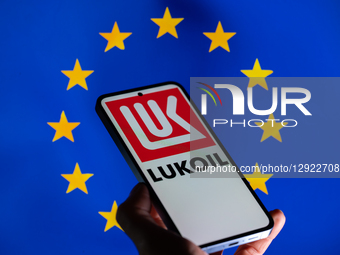 The Lukoil logo is displayed on a mobile phone with the European flag in the background, in this photo illustration in Brussels, Belgium, on... by Jonathan Raa/NurPhoto