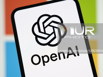 The OpenAI logo appears on a smartphone screen with the Microsoft logo in the background. Microsoft officially acquires a stake in OpenAI an... by Samuel Boivin/NurPhoto