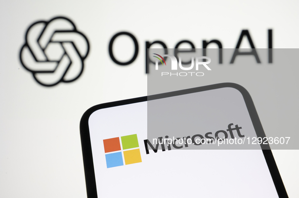 The Microsoft logo appears on a smartphone screen with the OpenAI logo in the background. Microsoft officially acquires a stake in OpenAI an... by Samuel Boivin/NurPhoto