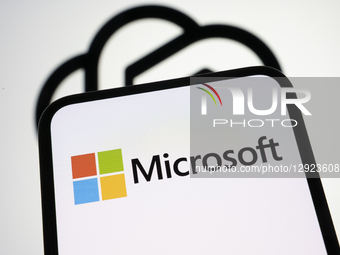 The Microsoft logo appears on a smartphone screen with the OpenAI logo in the background. Microsoft officially acquires a stake in OpenAI an... by Samuel Boivin/NurPhoto