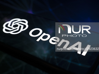 The OpenAI logo appears on a smartphone screen reflecting an abstract illustration dominated by blue. Microsoft officially acquires a stake... by Samuel Boivin/NurPhoto