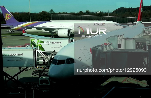 A Thai Airways plane taxis from the runway behind a parked Swiss Air aircraft at Zurich Airport in Switzerland, on October 28, 2025.  by Mike Campbell/NurPhoto