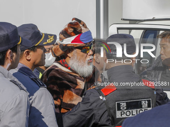 In Gimhae, South Korea, on October 30, 2025, South Korean police stop a Chinese denounce and pro-U.S. protesters shout their slogans near Gi... by Seung-il Ryu/NurPhoto