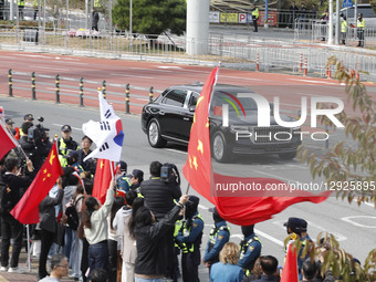 Chinese supporters wave Chinese flags as a motorcade believed to carry Chinese President Xi Jinping leaves Busan International Airport after... by Seung-il Ryu/NurPhoto