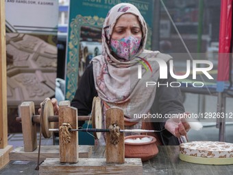 A Kashmiri woman artisan collects pashmina yarn after processing it on a traditional spinning wheel known as 'Yendir' during the 'Know Your... by Firdous Nazir/NurPhoto