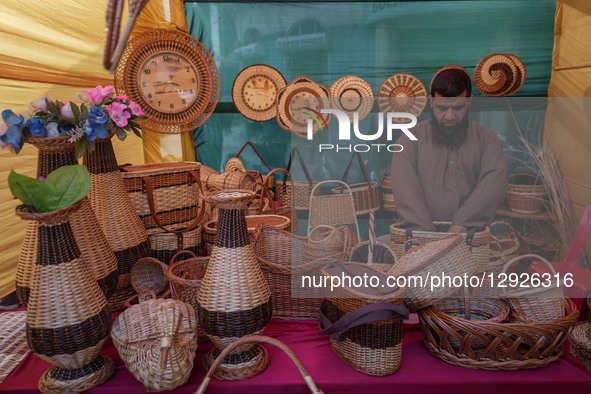 An artisan arranges wicker baskets on display during the 'Know Your Artisan' exhibition organized by the Department of Handicrafts and Handl... by Firdous Nazir/NurPhoto