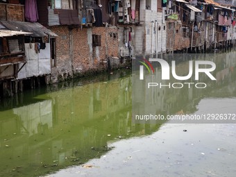 Houses stand tightly packed along the polluted Duri River at Tanjung Selor Street in Central Jakarta, Indonesia, on October 29, 2025. The st... by Donal Husni/NurPhoto