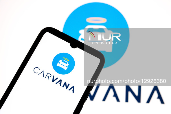 The Carvana logo appears on a smartphone screen and as the background on a laptop computer screen in this photo illustration in Athens, Gree... by Nikolas Kokovlis/NurPhoto