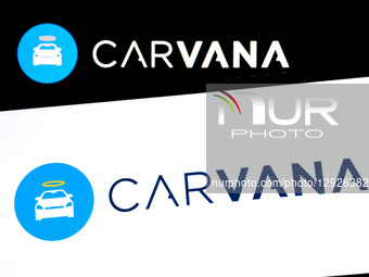 The Carvana logo appears on a smartphone screen and as the background on a laptop computer screen in this photo illustration in Athens, Gree... by Nikolas Kokovlis/NurPhoto