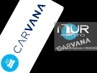 The Carvana logo appears on a smartphone screen and as the background on a laptop computer screen in this photo illustration in Athens, Gree... by Nikolas Kokovlis/NurPhoto