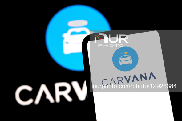The Carvana logo appears on a smartphone screen and as the background on a laptop computer screen in this photo illustration in Athens, Gree... by Nikolas Kokovlis/NurPhoto
