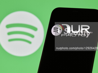 Close-up images show the Spotify logo and mobile application interface on a smartphone screen. The photos illustrate the popular music strea... by Matteo Della Torre/NurPhoto