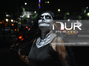 A lady dressed in a ghost costume poses for the camera as she participates in a dressing competition ahead of the Halloween celebration in K... by Debarchan Chatterjee/NurPhoto