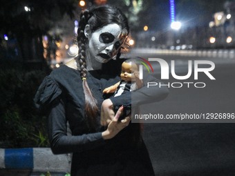 A lady dressed in a ghost costume poses for the camera as she participates in a dressing competition ahead of the Halloween celebration in K... by Debarchan Chatterjee/NurPhoto