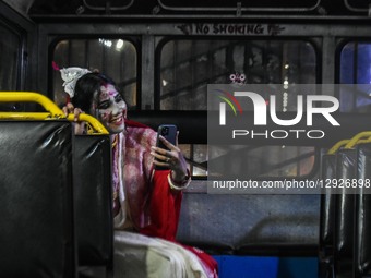 A lady dressed in a ghost costume poses for the camera as she participates in a dressing competition ahead of the Halloween celebration in K... by Debarchan Chatterjee/NurPhoto