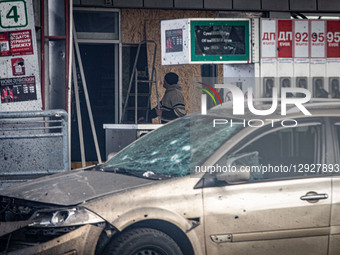 A worker boards up the door of a gas station after a Russian drone attack, on October 30, 2025.  by Francisco Richart Barbeira/NurPhoto