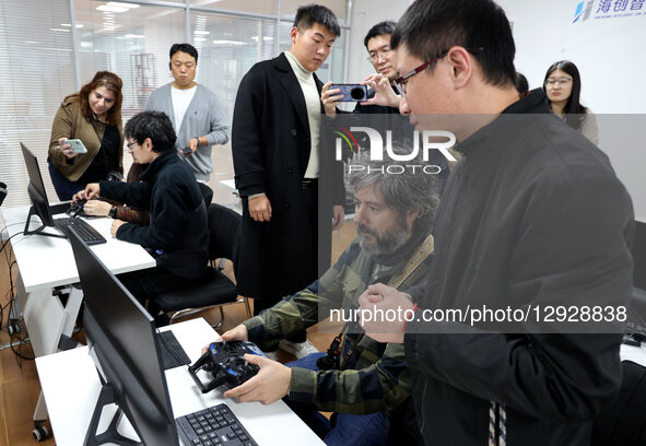 Foreign guests experience simulated flight operations at a drone manufacturing enterprise in the Binzhou High-tech Industrial Development Zo... by Costfoto/NurPhoto