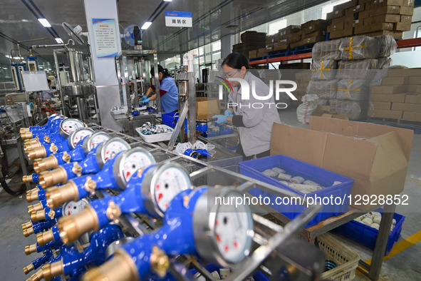 A worker works at a smart water meter manufacturing enterprise in Qingzhou Economic Development Zone, Qingzhou City, Shandong Province, Chin... by Costfoto/NurPhoto