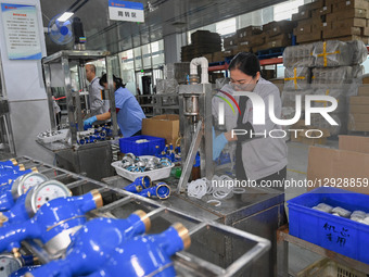 A worker works at a smart water meter manufacturing enterprise in Qingzhou Economic Development Zone, Qingzhou City, Shandong Province, Chin... by Costfoto/NurPhoto