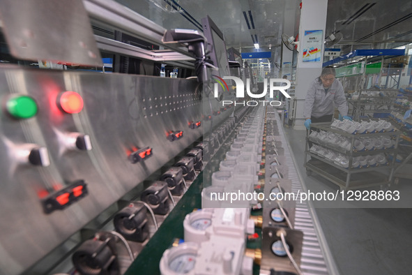 A worker works at a smart water meter manufacturing enterprise in Qingzhou Economic Development Zone, Qingzhou City, Shandong Province, Chin... by Costfoto/NurPhoto