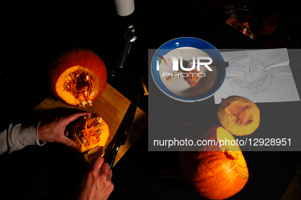 A man carves a pumpkin for the Halloween celebration in the Netherlands, on October 30, 2025.  by Romy Arroyo Fernandez/NurPhoto